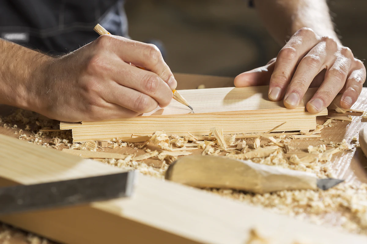 Carpenter cutting timber on site